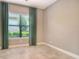 Well-lit bedroom with tile floors, large window, and neutral paint, creating a bright, comfortable space at 4020 Cascina Way, Sarasota, FL 34238