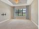 Carpeted bedroom with large window and neutral colors, providing a relaxing atmosphere at 4020 Cascina Way, Sarasota, FL 34238