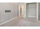Carpeted bedroom with walk-in closet, providing storage and organization at 4020 Cascina Way, Sarasota, FL 34238