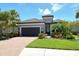 Charming single-Gathering home featuring a tile roof, well-maintained landscaping, and an attached two-car garage at 4020 Cascina Way, Sarasota, FL 34238