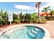A hot tub surrounded by lush landscaping provides a serene and luxurious spa-like experience at 4020 Cascina Way, Sarasota, FL 34238