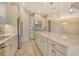 Spacious kitchen island with white cabinets, stainless steel appliances, and stylish pendant lighting at 4020 Cascina Way, Sarasota, FL 34238