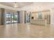 Bright, open kitchen with stainless steel appliances, a central island, and sliding glass doors to the outdoor area at 4020 Cascina Way, Sarasota, FL 34238