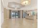 Open living space with a kitchen, tiled floors, and large sliding glass doors that let in natural light at 4020 Cascina Way, Sarasota, FL 34238