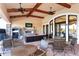 Enjoy outdoor seating by the fireplace and TV for relaxing and entertaining in a stylish outdoor space at 4020 Cascina Way, Sarasota, FL 34238
