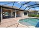 This screened-in lanai features a sparkling pool and relaxing outdoor living space with covered patio and brick pavers at 4020 Cascina Way, Sarasota, FL 34238