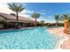 The community pool features ample seating and palm trees, offering a great place to relax and unwind at 4020 Cascina Way, Sarasota, FL 34238