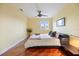 Comfortable bedroom featuring gleaming hardwood floors, a ceiling fan, and a cozy bed at 7716 Club Ln, Sarasota, FL 34238