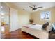 Comfortable bedroom featuring gleaming hardwood floors, a ceiling fan, and a cozy bed at 7716 Club Ln, Sarasota, FL 34238