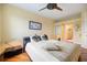 Bedroom features hardwood floors, a ceiling fan, and a stylish black side table at 7716 Club Ln, Sarasota, FL 34238