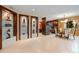 Open-concept dining area with glass shelving and seamless transition to kitchen at 7716 Club Ln, Sarasota, FL 34238