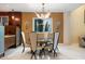 Elegant dining room features a modern chandelier, round table and four upholstered chairs at 7716 Club Ln, Sarasota, FL 34238