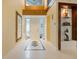 Elegant foyer features a high ceiling, decorative mirror, and tiled floor, creating a grand entrance at 7716 Club Ln, Sarasota, FL 34238