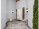 Inviting front entrance with a stylish white door, modern lighting, and manicured landscaping at 7716 Club Ln, Sarasota, FL 34238