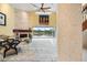 Spacious living room with stone fireplace and sliding doors overlooking a lake at 7716 Club Ln, Sarasota, FL 34238