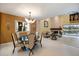 Open-concept living and dining areas with fireplace and lake views at 7716 Club Ln, Sarasota, FL 34238