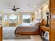 Main bedroom with lake views, a ceiling fan and a sitting area at 7716 Club Ln, Sarasota, FL 34238