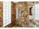 Luxurious walk-in shower with glass block window and marble tile at 7716 Club Ln, Sarasota, FL 34238
