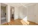 Bright bedroom with hardwood floors, closet with louvered doors, and an ensuite bathroom at 1774 10Th St, Sarasota, FL 34236