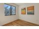 Minimalist bedroom with wood floors, a large window, and modern art at 1774 10Th St, Sarasota, FL 34236