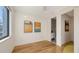 Bright bedroom with hardwood floors, minimalist decor, and ensuite access to bathroom at 1774 10Th St, Sarasota, FL 34236