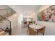 Dining area with modern decor, flowing to the kitchen with sleek stairs and modern art at 1774 10Th St, Sarasota, FL 34236