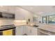 Modern kitchen with stainless steel appliances, granite countertops, and contemporary white cabinets at 1774 10Th St, Sarasota, FL 34236
