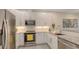 Bright kitchen featuring stainless steel appliances, granite countertops, and white cabinetry at 1774 10Th St, Sarasota, FL 34236