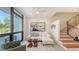 Sun-filled living room featuring modern stairs, comfortable seating, and stylish decor at 1774 10Th St, Sarasota, FL 34236