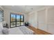 Serene main bedroom with large window, closet with shutter doors, and wood floors at 1774 10Th St, Sarasota, FL 34236