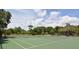 Aerial view of tennis courts surrounded by mature trees on a sunny day at 1774 10Th St, Sarasota, FL 34236