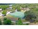 Aerial view of community tennis courts surrounded by mature trees and lush landscaping at 1774 10Th St, Sarasota, FL 34236
