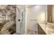 The bathroom features a walk-in shower with marble tile and a vanity with granite countertops and a mirror at 1778 10Th St, Sarasota, FL 34236