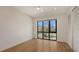 A well-lit bedroom features a large window, hardwood floors, and a closet, providing ample storage space at 1778 10Th St, Sarasota, FL 34236