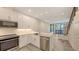 Bright open kitchen with stainless steel appliances and modern white cabinets at 1778 10Th St, Sarasota, FL 34236