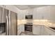 Modern kitchen featuring stainless steel appliances, white cabinets and granite countertops at 1778 10Th St, Sarasota, FL 34236