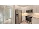 Kitchen with stainless steel refrigerator and oven, with modern white cabinetry and backsplash at 1778 10Th St, Sarasota, FL 34236