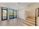 Bright living area features tiled floors, large windows, and a staircase at 1778 10Th St, Sarasota, FL 34236