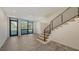 Living room with large windows, tile flooring, and staircase at 1778 10Th St, Sarasota, FL 34236