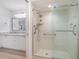 Bright bathroom featuring walk-in shower and granite-topped double vanity with white cabinets at 3920 Bal Harbor Blvd # E1, Punta Gorda, FL 33950