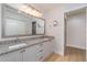 Elegant bathroom features double sinks, granite counters, and a large mirror at 3920 Bal Harbor Blvd # E1, Punta Gorda, FL 33950