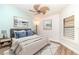 Bright bedroom features a ceiling fan, stylish decor, and wood-look floors at 3920 Bal Harbor Blvd # E1, Punta Gorda, FL 33950