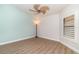A bright bedroom with wood-look flooring and shuttered window at 3920 Bal Harbor Blvd # E1, Punta Gorda, FL 33950