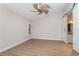 Spacious bedroom with ceiling fan, wood-look floors, and a barn door at 3920 Bal Harbor Blvd # E1, Punta Gorda, FL 33950