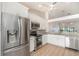 Spacious kitchen featuring stainless steel appliances, white cabinetry, and a vaulted ceiling with fan at 3920 Bal Harbor Blvd # E1, Punta Gorda, FL 33950