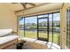 Enclosed lanai with ceiling fan boasts beautiful waterfront views and relaxing seating area at 3920 Bal Harbor Blvd # E1, Punta Gorda, FL 33950