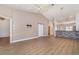 Open-concept living room featuring high ceilings, wood flooring, and stylish barn door accent at 3920 Bal Harbor Blvd # E1, Punta Gorda, FL 33950