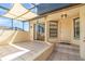Inviting screened-in patio with tiled floor, shade covering, and convenient access to the home's entrance at 3920 Bal Harbor Blvd # E1, Punta Gorda, FL 33950