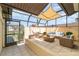 Enclosed patio featuring tile flooring, comfortable seating, and unique sun shade at 3920 Bal Harbor Blvd # E1, Punta Gorda, FL 33950