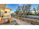 Balcony with table and chairs overlooking a landscaped street with mature trees at 501 Outrigger Ln, Longboat Key, FL 34228